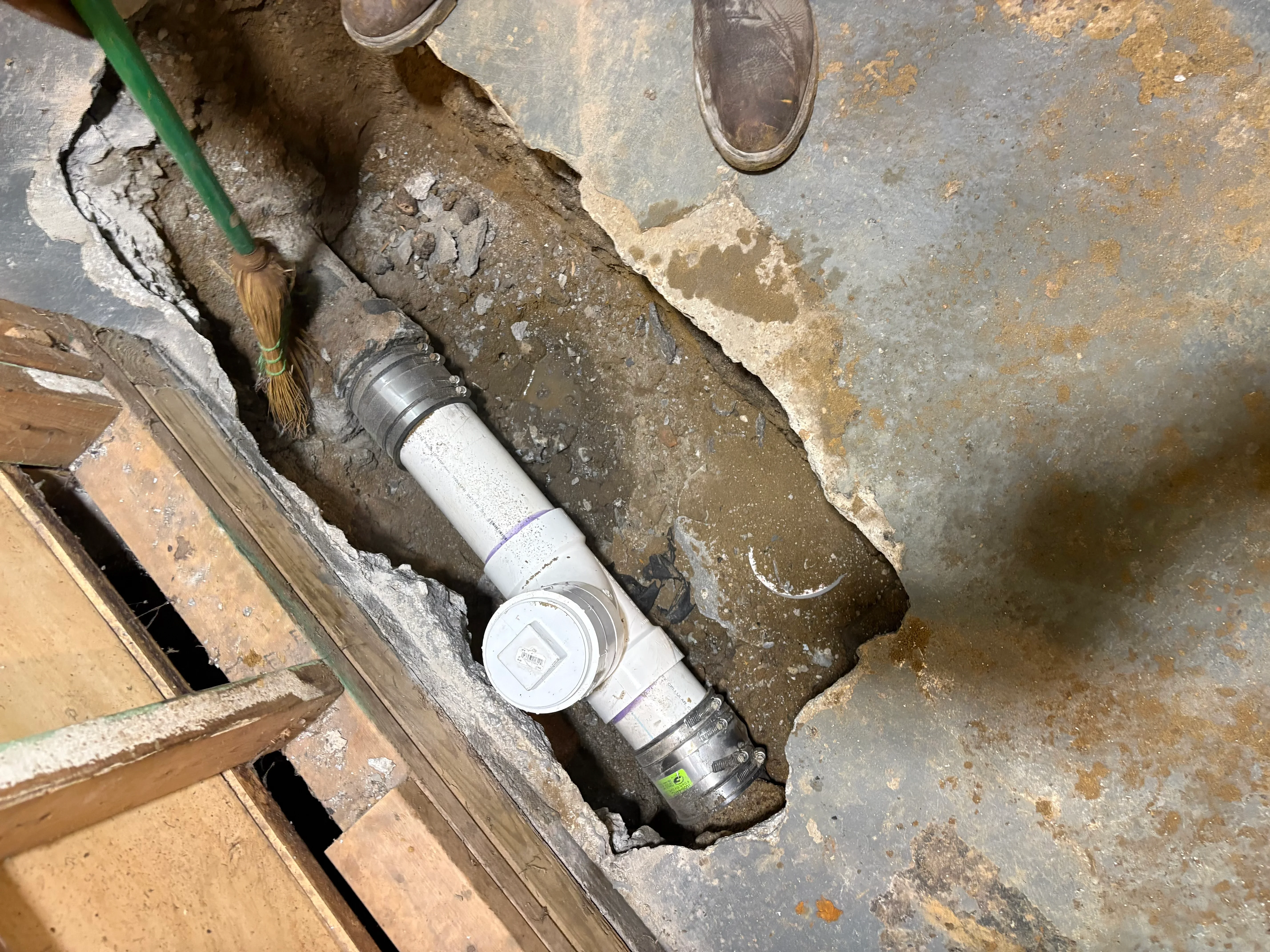 Water meter installation with PVC piping and brass fittings in underground utility pit
